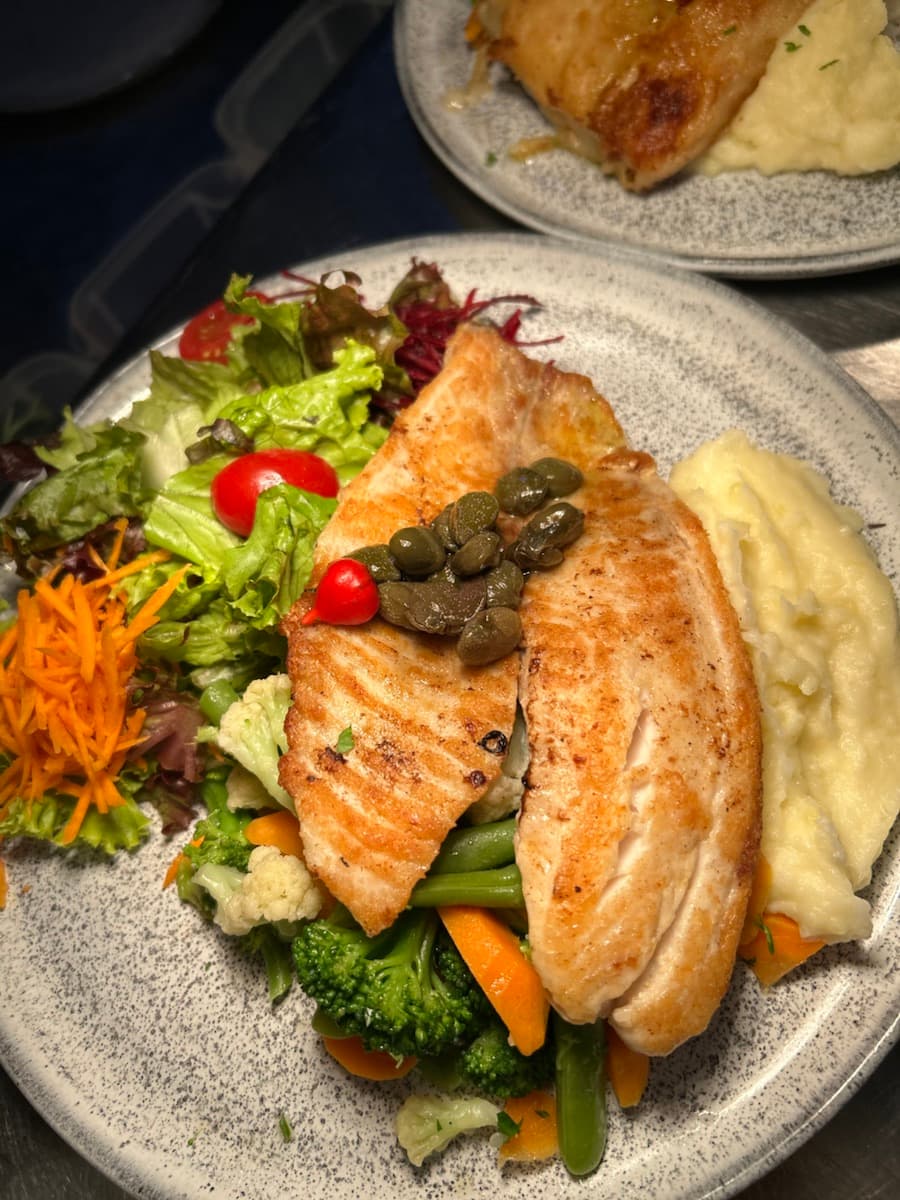 Prato de peixe com legumes servido no Zin Bar